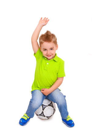 Little boy sitting on  soccer ball isolatedの写真素材