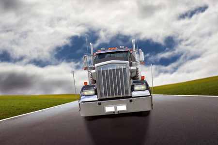 american truck driving on country roadの写真素材