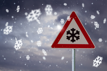 traffic sign snow with dark sky and snowflakesの写真素材