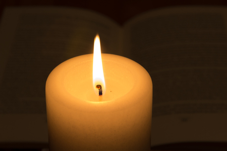 burning candle with bibleの写真素材
