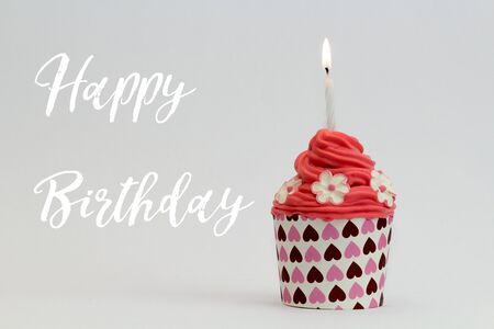 Happy birthday cupcake with burning candleの写真素材