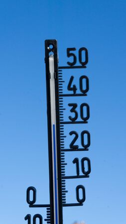 thermometer against a blue skyの写真素材