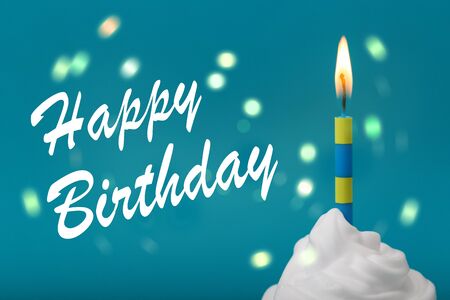 Burning candle on a cupcake with text happy birthdayの写真素材