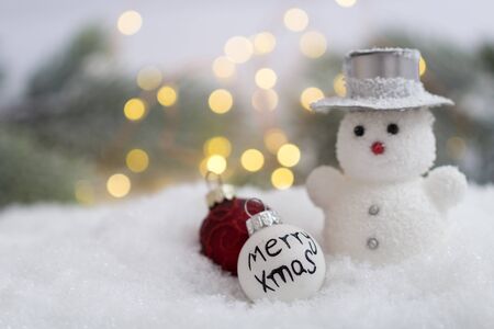 Snowman doll in winter landscape with decorationの写真素材