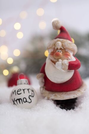 Santa Claus doll in winter landscape with decorationの写真素材
