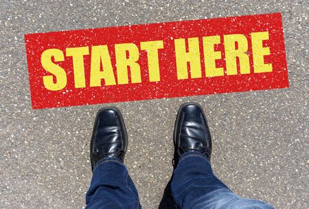 Top view of business shoes on the floor with the text: START HERE