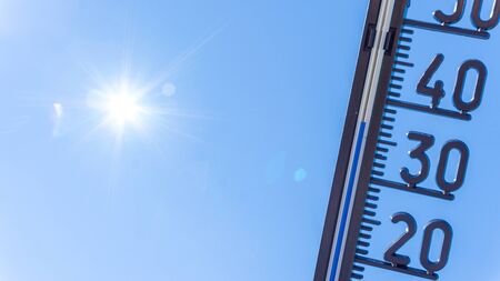 Thermometer shows high temperature in summerの写真素材