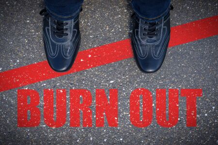 Top view of business shoes on the floor with the text: Burn Outの写真素材