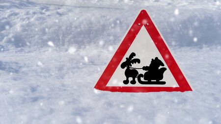 Red road sign with Santa and reindeer in the snowの写真素材