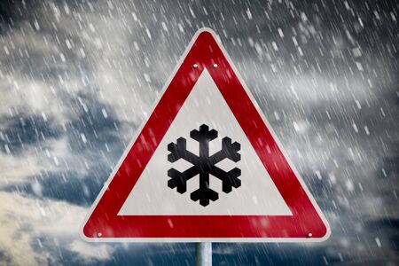 winter driving - warning sign - risk of snow and iceの写真素材