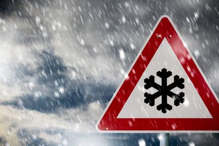 winter driving - traffic sign - risk of snow and iceの写真素材