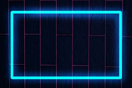 Blue neon light on a brick wall at nightの写真素材