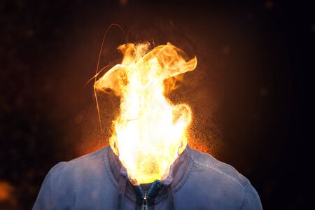 Stressed young man with fire head.の写真素材