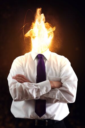 Stressed business man with fire head.の写真素材