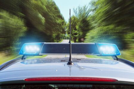 Police car driving on country road
