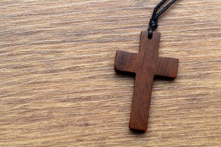 Wooden cross on wooden backgroundの写真素材