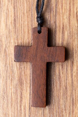 Wooden cross on wooden backgroundの写真素材