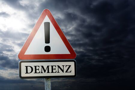 Dementia, Alzheimer's, Forgotten - road sign against a dark cloudy skyの写真素材