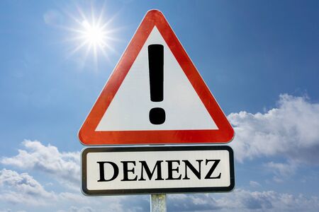 Dementia, Alzheimer's, Forgotten - road sign against a blue sky with the sunの写真素材