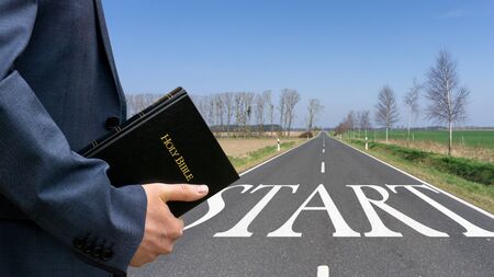 Man holding bible in his hand. Concept for faith, spirituality and religionの写真素材