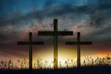 Three wooden crosses at sunriseの写真素材