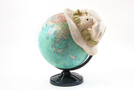 Globe with a hat on a white background.の写真素材