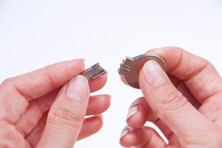 The broken house key in hand.の写真素材