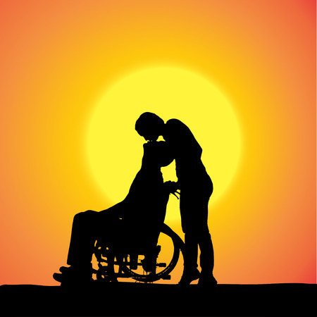silhouettes of people in a wheelchair at sunset. のイラスト素材