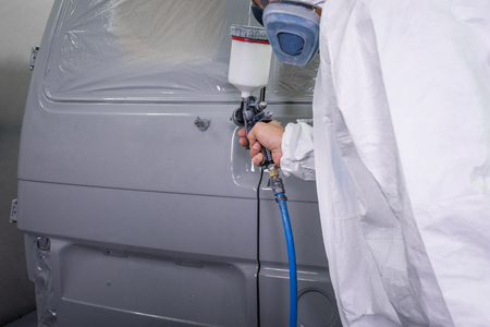 Painter spray gun in the hands of a painter.の写真素材