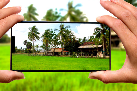 Woman with mobile phone photos experiences the tours of asia.の写真素材