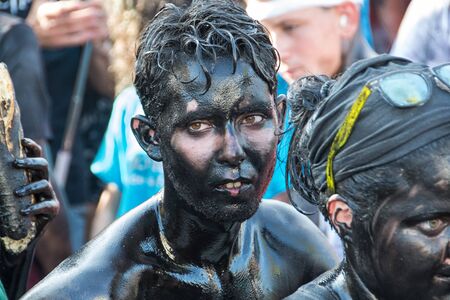 BAZA, SPAIN - SEPTEMBER 6, 2018: Holiday Cascamorras in Baza in Spain when people painted black oil running down the streetのeditorial素材