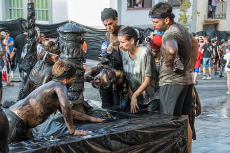 BAZA, SPAIN - SEPTEMBER 6, 2018: Holiday Cascamorras in Baza in Spain when people painted black oil running down the streetのeditorial素材