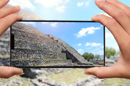 Taking photo by mobile phone pyramid in Mexico.の写真素材
