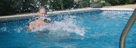 Father and daughter enjoying swimming pool.