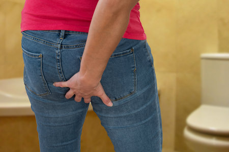Closeup of woman with intestinal problems on bathroom.の写真素材
