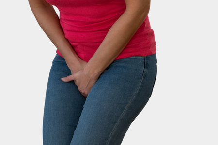 Woman with Hands Holding her Crotch in White Backgroundの写真素材