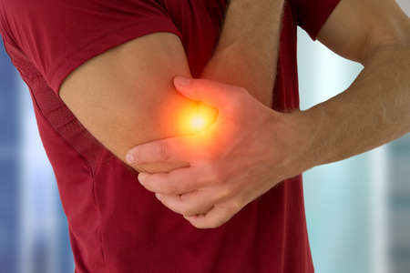 Health problem concept man suffering from elbow pain.の写真素材
