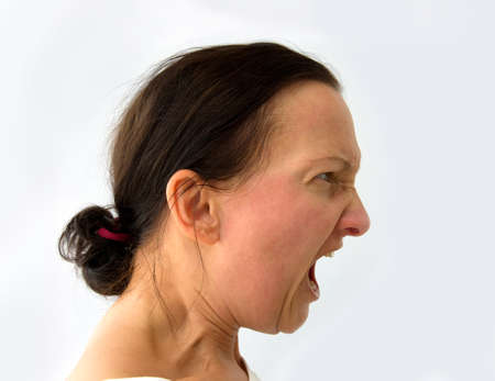 Angry woman screaming on white background.の写真素材