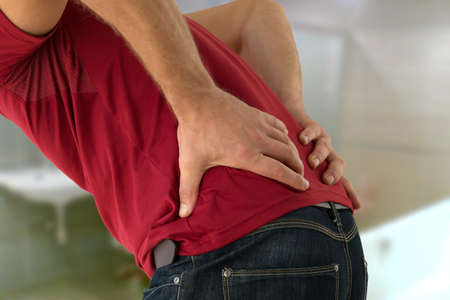 Health problem concept man suffering lower back pain.の写真素材