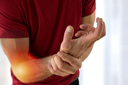 Health problem concept man suffering from elbow pain.の写真素材