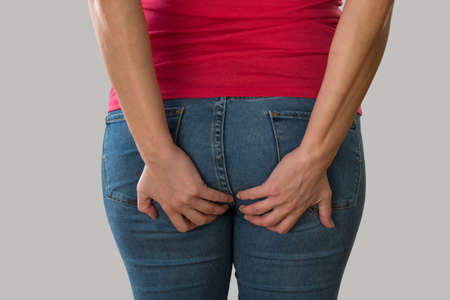 Woman with health problems. Hemorrhoids and intestinal issues.の写真素材