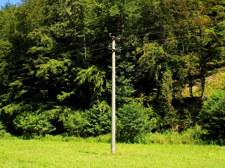 Power line column on meadowの写真素材