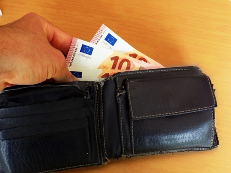 Men pulls out money, euro banknotes of wallet