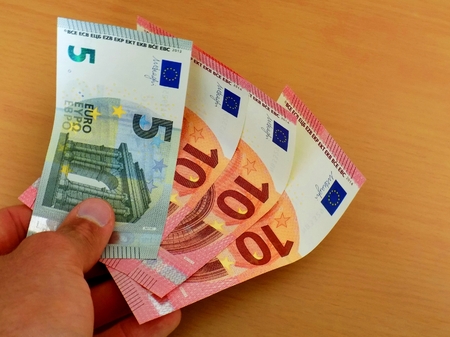 Men holding euro banknotes money