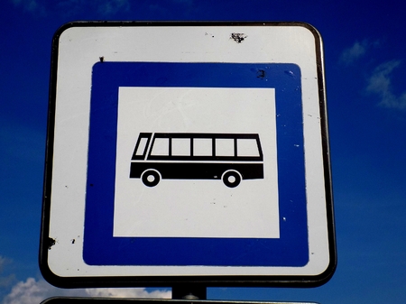 Bus roadsign (bus stop) near asphalt road in cityの写真素材
