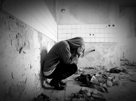 Sitting women in depression, young sadness women crying in old dirty abandoned houseの写真素材