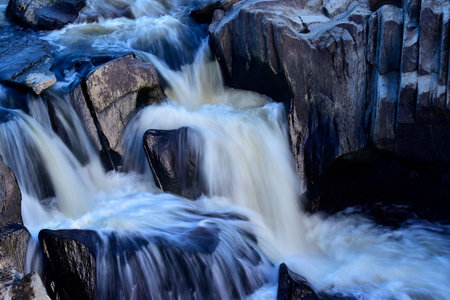 Waterfall with a slow-moving effect forming silks with the water.の写真素材