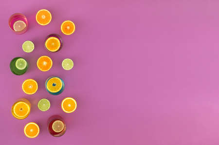 Fresh fruit halved and laid on a purple suface or in a glass cups. Minimal concept.