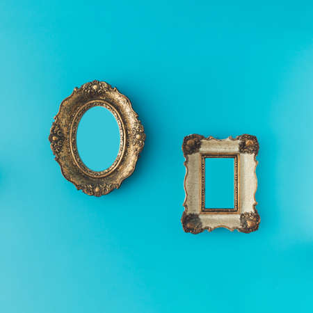 Vintage ornamental photo and picture frame on blue background. Minimal concept.の写真素材
