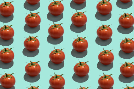 Seamless creative food pattern. Fresh tomatoes on a blue background. Colorful food concept.の写真素材
